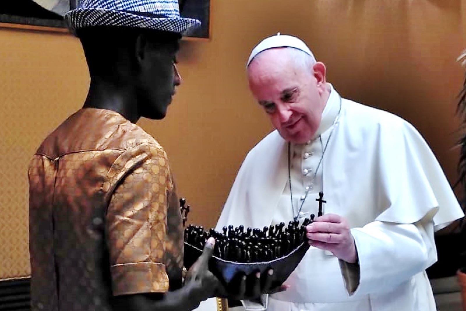 Arouna receiving a gift from Pope Francis at the Vatican.